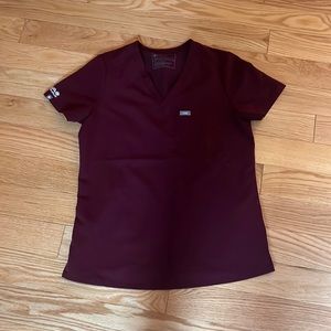 Figs small maroon scrub top. Small Aya logo on right arm